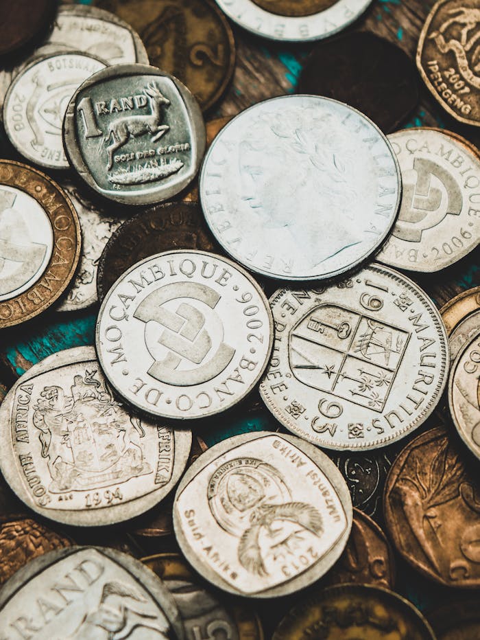 Close-up shot of various international coins showcasing currency diversity.